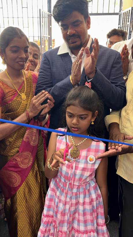 A young girl cuts the ribbon to open a new AROKK branch